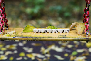 Word DEPRESSION composed of wooden letters.